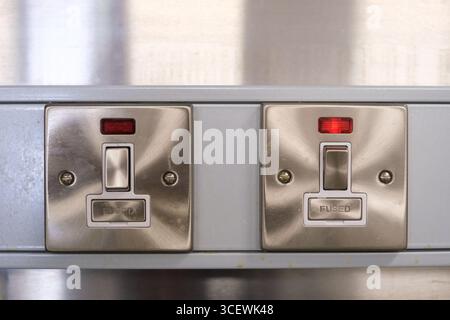 Two stylish electrical switches and sockets are displayed, complete with fuses, designed for safety in homes and offices in a modern English environme Stock Photo
