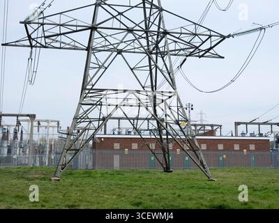 Pylons at 400â€¯kV electricity substation. A substation is a crucial component of the National Grid's extra-high-voltage transmission network. It connects, monitors, and controls incoming and outgoing 400 kV circuits. The substation utilises large transformers, switchgear, and protection equipment to adjust voltage levels, isolate faults, and ensure the safe and efficient bulk transfer of electricity over long distances. Stock Photo