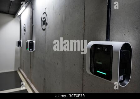 A row of charging stations for electric cars are mounted on a wall. The stations are labeled with the word "Circuiter" Stock Photo