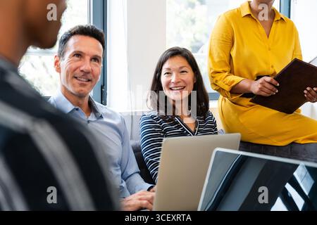 Startup business team members are discussing new strategies during a productive meeting in a modern office, fostering collaboration and innovation Stock Photo
