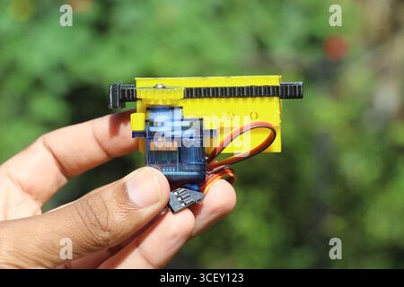 3D printed gear and slider or linear actuator mechanism installed on a micro servo module for small robotic applications Stock Photo