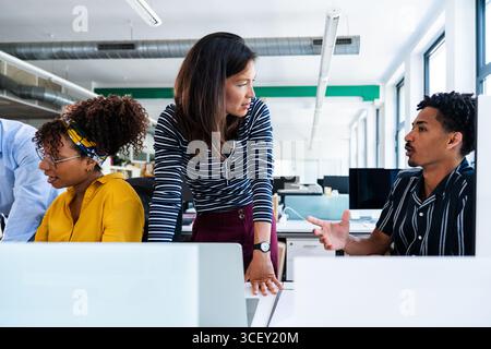 Startup business team working together on project, communicating and collaborating in modern office environment, sharing ideas and strategies for succ Stock Photo