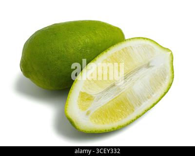 Fresh green lemon, whole and sliced half, isolated on white background Stock Photo