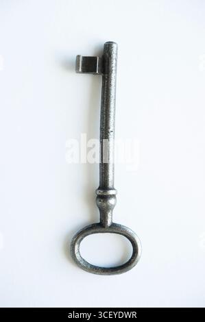 Vintage metal key isolated on white background, symbol of security and unlocking Stock Photo