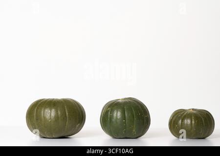 Three green pumpkins isolated on a white background Stock Photo