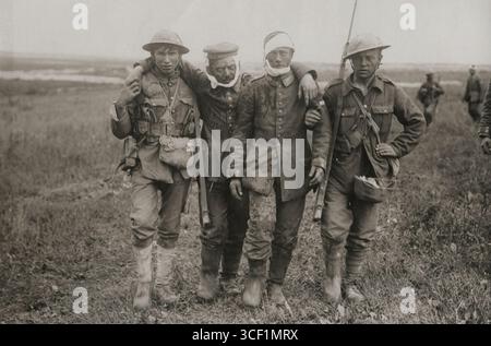 German prisoners assist British soldiers to bring in the wounded. Near ...
