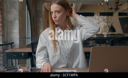 Caucasian business woman confused trouble thinking about financial data diagram corporate results in office businesswoman female girl pensive Stock Photo