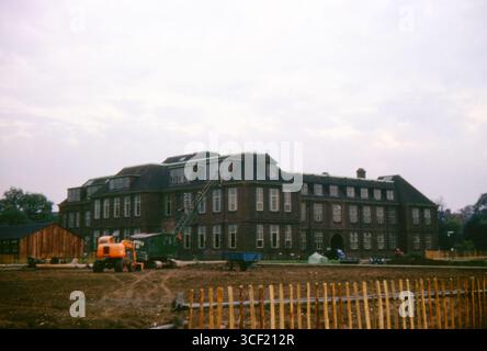 Construction site with crane and equipment beside university buildings, University of Hull campus, England, November 1963. 35mm slide film. Stock Photo