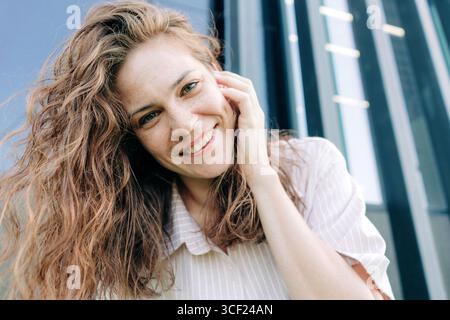 Happy smiling red-haired woman looking at the camera. Stock Photo