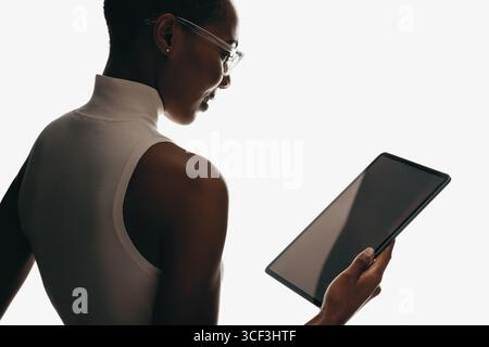 Confident woman holding a tablet. The image reflects modern technology and professionalism. Stock Photo