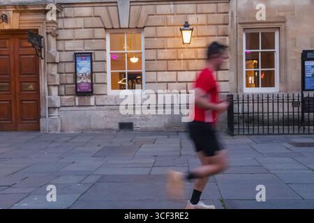 England, Somerset, Bath, Jogger passing The Pump Room Stock Photo