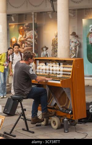 England, Somerset, Bath, Stall Street, Busker Playing Piano Stock Photo