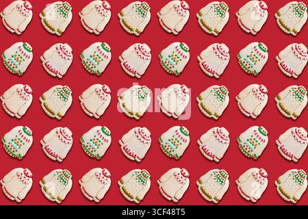 Ugly sweater Christmas cookies pattern on red background Stock Photo