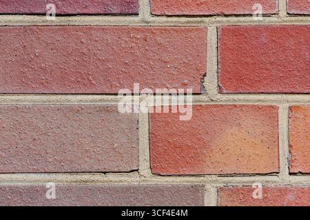 Bright and consistent brick pattern with sandy-colored mortar. Looks new, neat, and modern, but with dicolorations. Stock Photo
