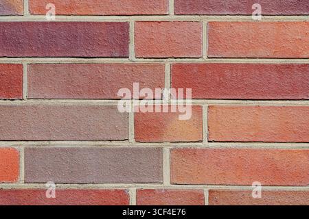 Bright and consistent brick pattern with sandy-colored mortar. Looks new, neat, and modern, but with imperfections. Stock Photo