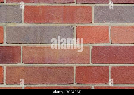 Bright and consistent brick pattern with sandy-colored mortar and yellow stains. Stock Photo
