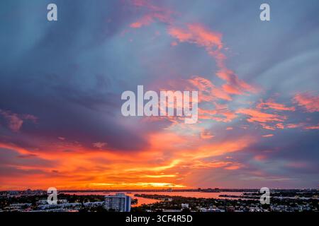 Miami Beach Florida,North Beach,Biscayne Bay,sunset sky clouds colorful,aerial overhead view from above looking down,climate change global warming,bri Stock Photo