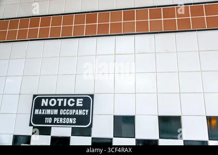 Coral Gables Miami Florida,Bagel Emporium & Grille,cafe restaurant Jewish food,inside interior,notice sign maximum occupancy 110 persons,black white l Stock Photo