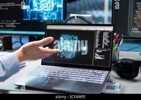 Close up of admin in data center troubleshoots rigs connectivity issues using deep learning tech on laptop. IT professional using notebook in server hub, auditing systems for vulnerabilities using AI Stock Photo