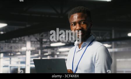 Smiling technician and colleague in data center reviewing large language model visualizations on PC. Happy IT engineering team analyzing neural network performance outputs Stock Photo