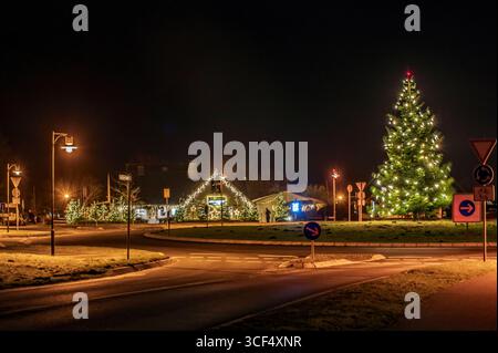 Light trails on the traffic circle with Christmas decorations Stock Photo