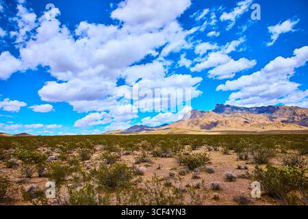 Desert Landscape with Mountain Ridge and Dramatic Cloud Filled Sky Stock Photo