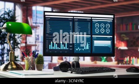 Empty modern desktop ready for business development work with infographics, sleek monitor in a classy urban loft. Artistic interior design and tools for marketing and website growth. Stock Photo