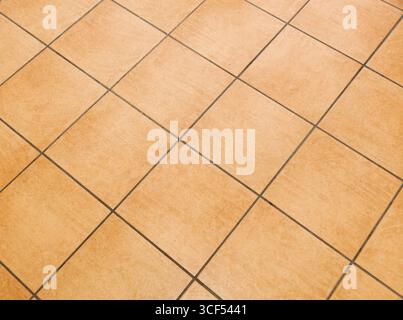 Brown ceramic floor tiles close up texture. Stock Photo
