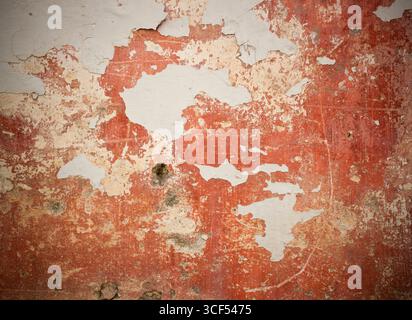 Cracked and peeling paint and grunge old wall with texture. Stock Photo