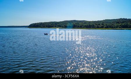 Boat trip from Rügen to Hiddensee – small solitary boat on calm Baltic Sea waters. Stock Photo