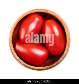 Fresh plum tomatoes, Roma tomatoes in wooden bowl. Also known as processing or paste tomatoes, oval shaped, used for canning or producing tomato paste. Stock Photo
