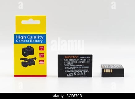 Bologna - Italy - July 13, 2025: High quality Shantec li-ion camera battery and its yellow packaging isolated on white background. Stock Photo