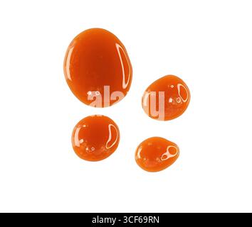 Drops of melted caramel, syrup isolated on white, clipping path, top view Stock Photo