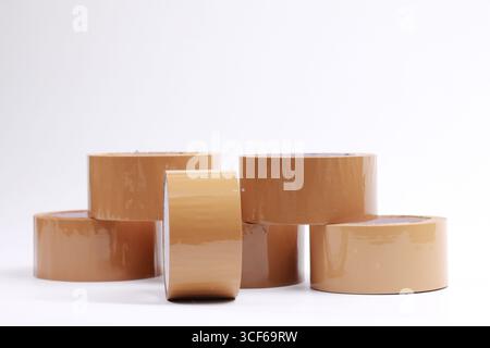 Stack of brown adhesive tape rolls. Isolated on white background. Stock Photo