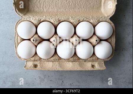 Package with ten white chicken eggs, top view Stock Photo
