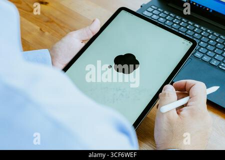 Adult male using OPEN AI ChatGPT on a smartphone. Artificial intelligence technology. Smartphone closeup. Male hands using AI on phone. High quality Stock Photo