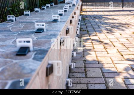 Close-up view of a tile leveling system securing ceramic tiles on an outdoor patio, perfect for construction and renovation concepts. Stock Photo