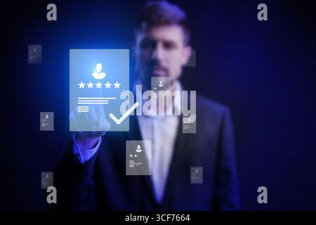 Man interacting with digital interface displaying reviews and profiles in modern office setting Stock Photo
