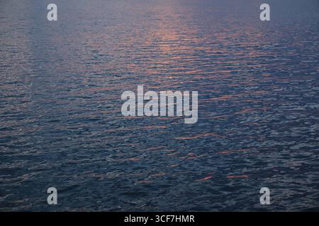 Colorful reflection of the sunset in the water surface Stock Photo
