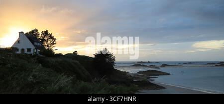 Isolated house in french Brittany at the sunset with beautiful color gradient in the sky Stock Photo