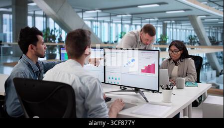 Multiracial Team Analyzing Performance Data On Computer Dashboard Screen Stock Photo