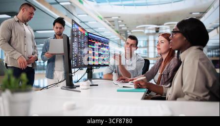 Black Businesswoman Managing Diverse Team Using Kanban Software In Office. Stock Photo