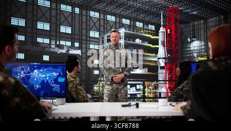 Team Meeting Of Diverse Professionals In Rocket Construction Facility Stock Photo