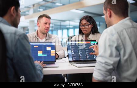 Businessman And Diverse Team Using Online Scheduler For Meeting Goals. Stock Photo