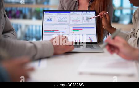 Multicultural Team Analyzing Demographic Data For Financial Predictions In Office Stock Photo
