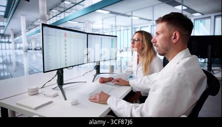 Doctor In Hospital Office Analyzing Budget And Coding Medical Invoices. Stock Photo