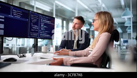 Two Software Developers Collaborating On Business Application Coding Methodology Stock Photo