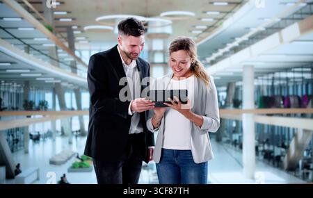Business Professionals Smiling At Coffee Shop Meeting, Collaborative Discussion Stock Photo