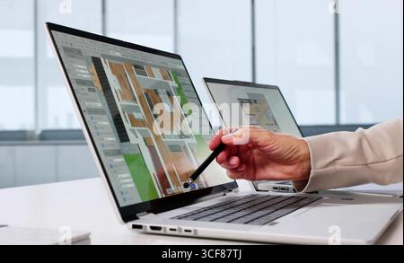 Elderly Woman Using Virtual Design Software To Remodel Real Estate Stock Photo