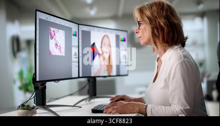 Elderly Graphic Designer Works Late From Home On Colorful Projects Stock Photo